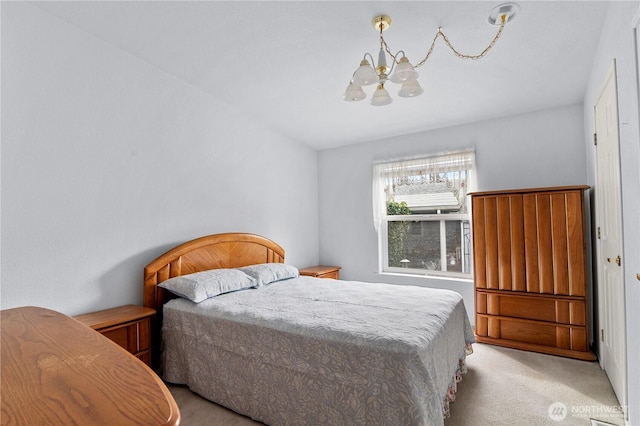 bedroom featuring an inviting chandelier and carpet floors