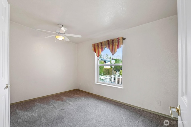 unfurnished room with baseboards, a ceiling fan, and carpet floors