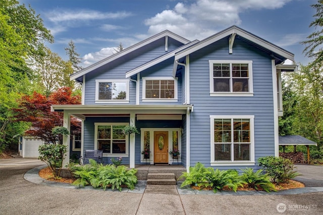 view of front of property with a garage and covered porch