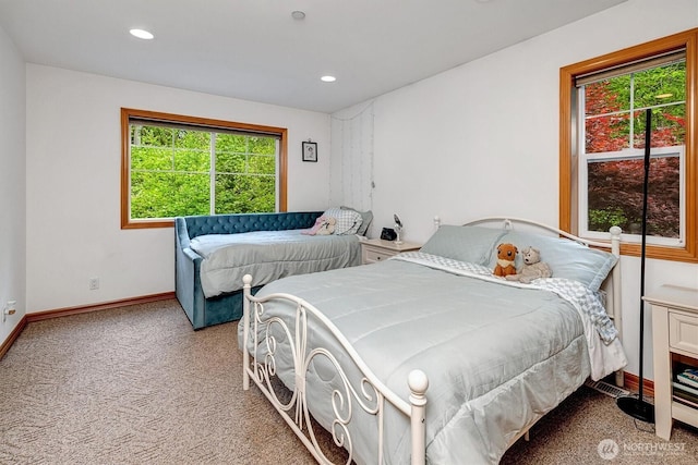 carpeted bedroom featuring baseboards and recessed lighting