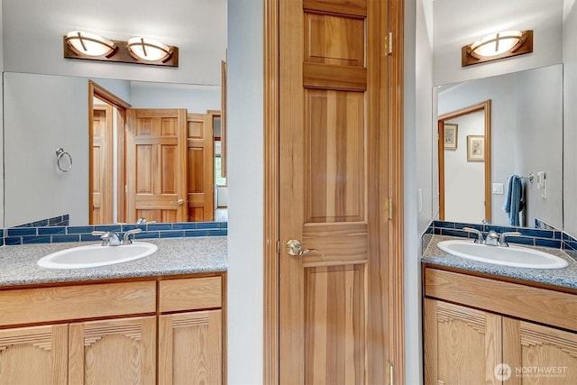 bathroom featuring two vanities and a sink