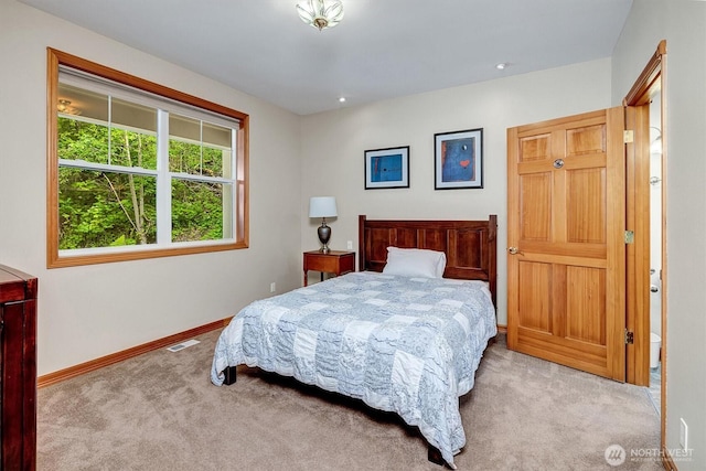 bedroom with carpet floors, baseboards, and visible vents