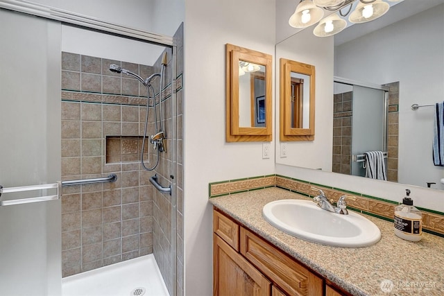 full bath with a shower stall and vanity