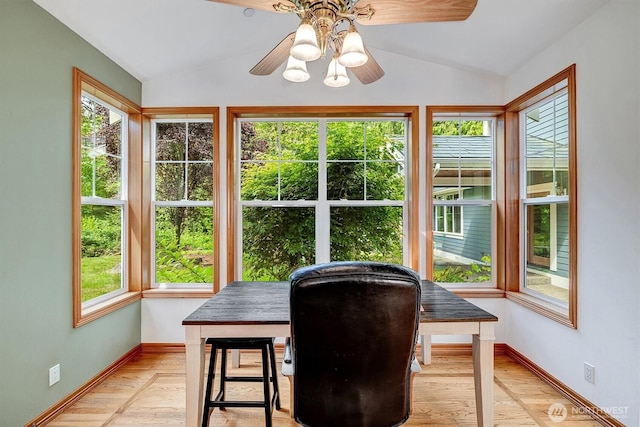 interior space featuring lofted ceiling, ceiling fan, and a healthy amount of sunlight