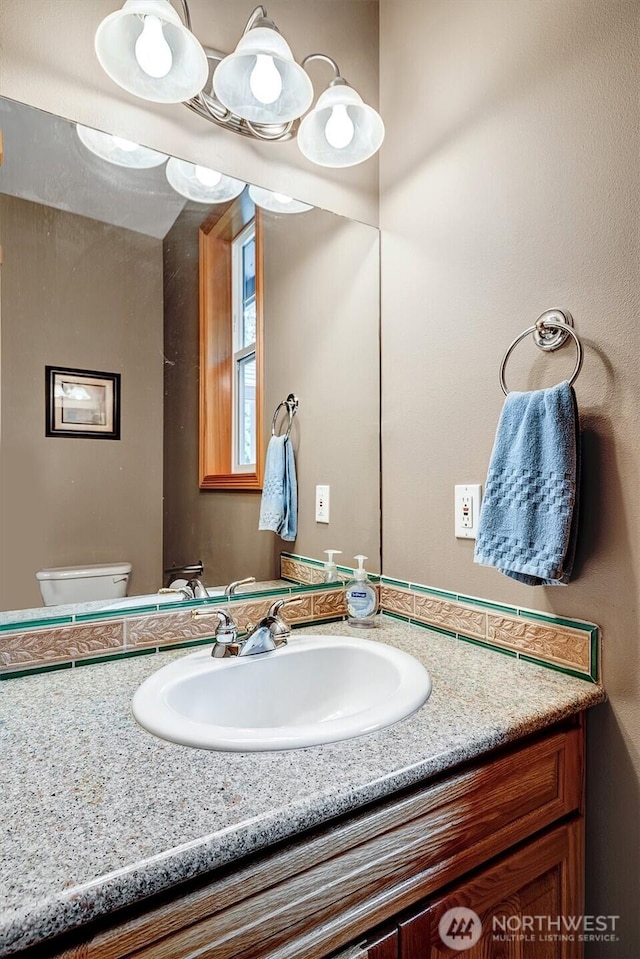 bathroom featuring vanity and toilet