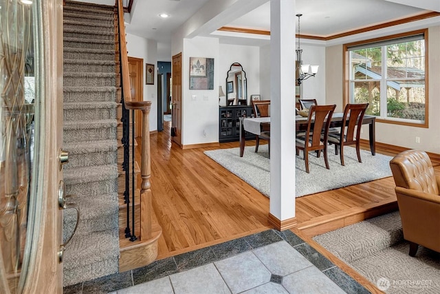 interior space with a chandelier, recessed lighting, wood finished floors, baseboards, and stairway