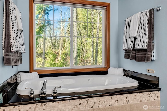 full bath with a garden tub and plenty of natural light