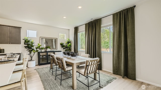 dining room with baseboards, recessed lighting, and light wood-style floors