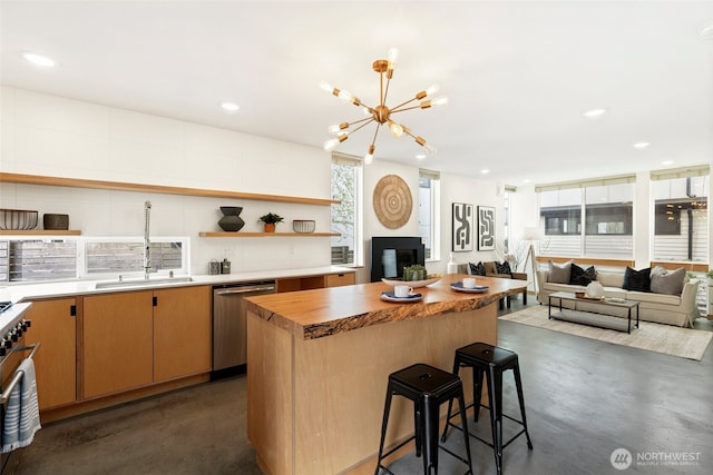 kitchen with open shelves, concrete floors, appliances with stainless steel finishes, and a sink