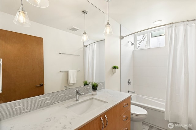 bathroom with visible vents, shower / bath combo with shower curtain, toilet, tasteful backsplash, and vanity