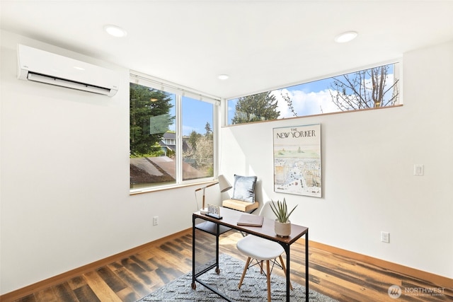 office area featuring recessed lighting, a wall mounted AC, baseboards, and wood finished floors