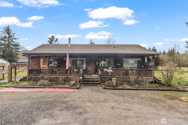 view of front of home featuring roof with shingles