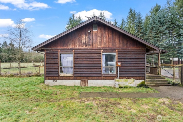 view of property exterior featuring crawl space and a lawn