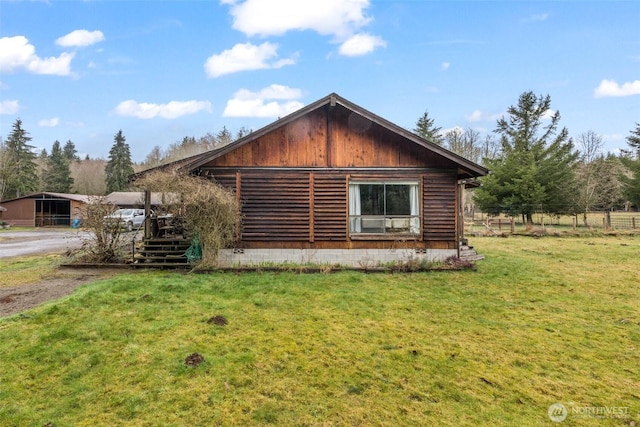 view of side of property with a lawn
