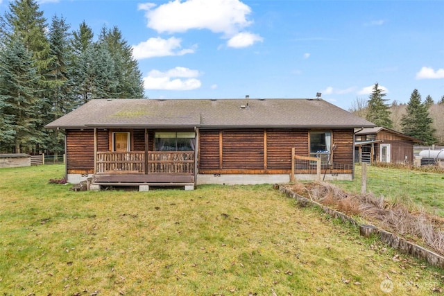 rear view of property with a yard