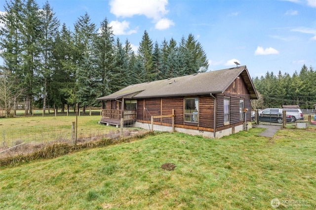 exterior space with fence and a front lawn