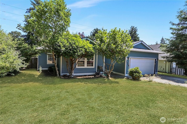 view of property hidden behind natural elements with driveway, an attached garage, fence, and a front yard