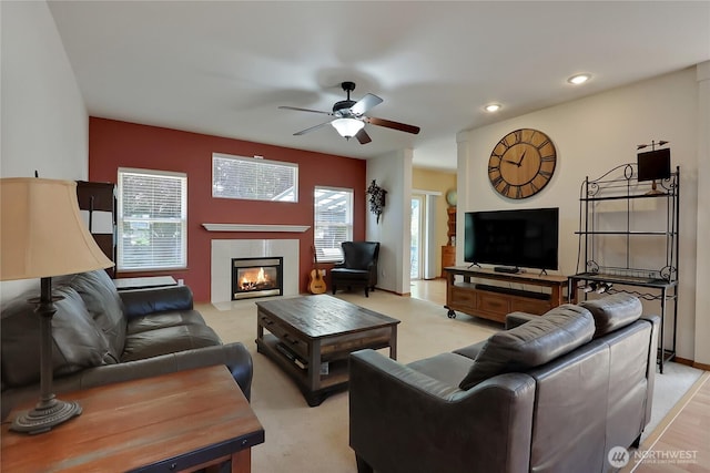 living area with light carpet, ceiling fan, a fireplace, and recessed lighting