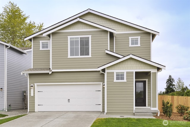 view of front of property with driveway, an attached garage, and fence