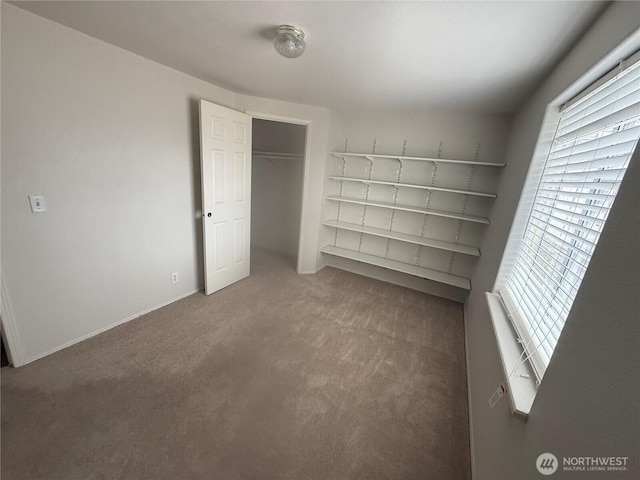 unfurnished bedroom featuring a closet and carpet floors