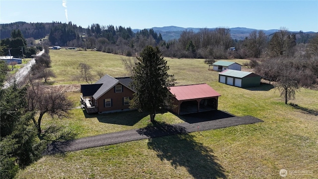 birds eye view of property with a rural view, a wooded view, and a mountain view