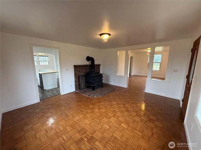 106 Alder St, Pe Ell, WA 98572 - unfurnished living room with a wood stove and baseboards
