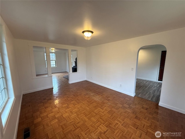 106 Alder St, Pe Ell, WA 98572 - spare room featuring arched walkways, visible vents, and baseboards