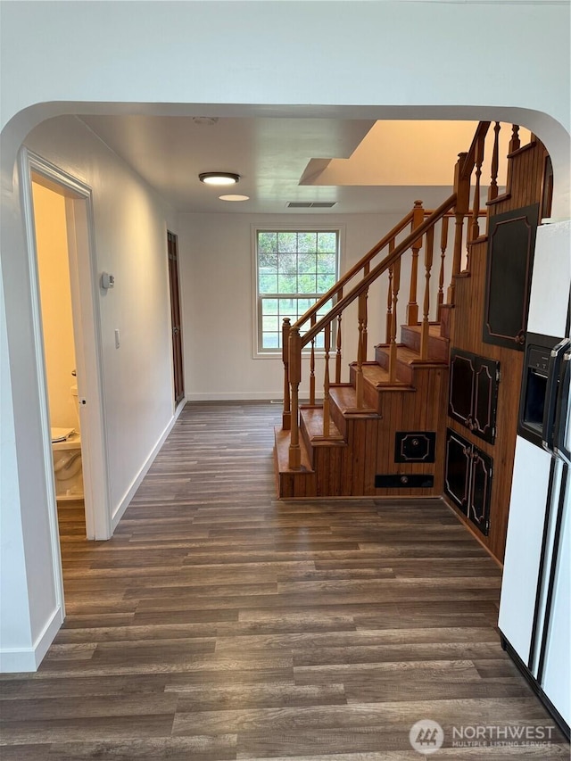 106 Alder St, Pe Ell, WA 98572 - stairs with visible vents, arched walkways, and wood finished floors