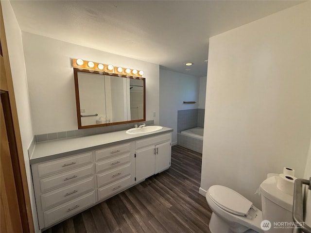106 Alder St, Pe Ell, WA 98572 - bathroom with a garden tub, vanity, wood finished floors, and toilet