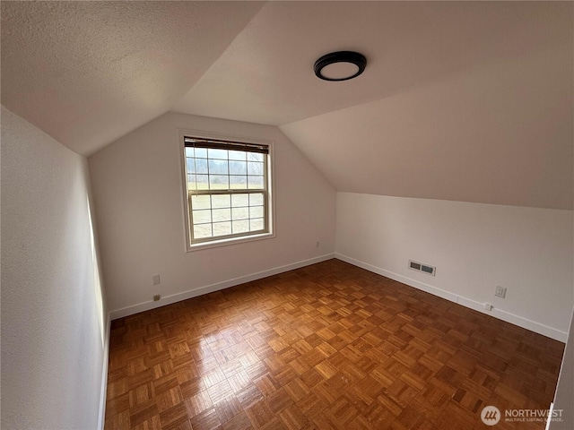 106 Alder St, Pe Ell, WA 98572 - additional living space with lofted ceiling, visible vents, a textured ceiling, and baseboards