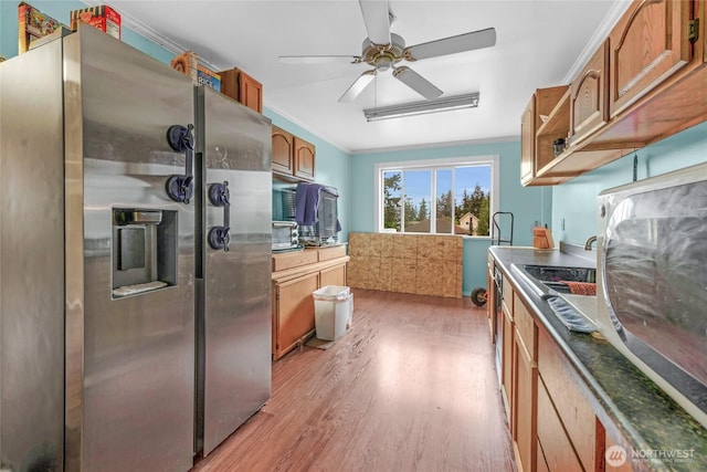 723 E 54th St, Tacoma, WA 98404 - kitchen featuring a ceiling fan, light wood-type flooring, brown cabinets, stainless steel fridge, and crown molding