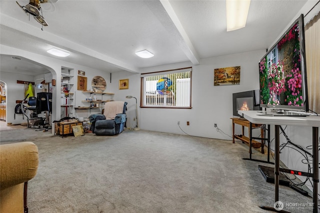 723 E 54th St, Tacoma, WA 98404 - living area featuring arched walkways, carpet, and beam ceiling