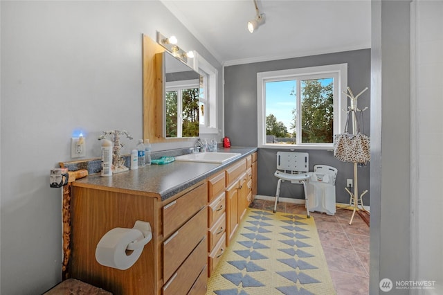 723 E 54th St, Tacoma, WA 98404 - bathroom with baseboards, tile patterned floors, rail lighting, crown molding, and vanity