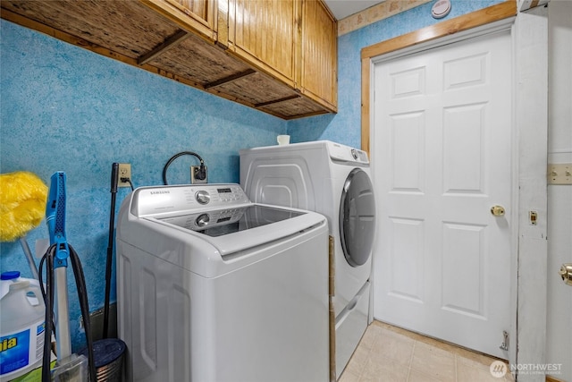 723 E 54th St, Tacoma, WA 98404 - washroom featuring wallpapered walls, light tile patterned floors, cabinet space, and independent washer and dryer