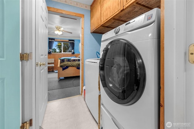 723 E 54th St, Tacoma, WA 98404 - laundry area featuring cabinet space, ceiling fan, washer and dryer, and light tile patterned flooring