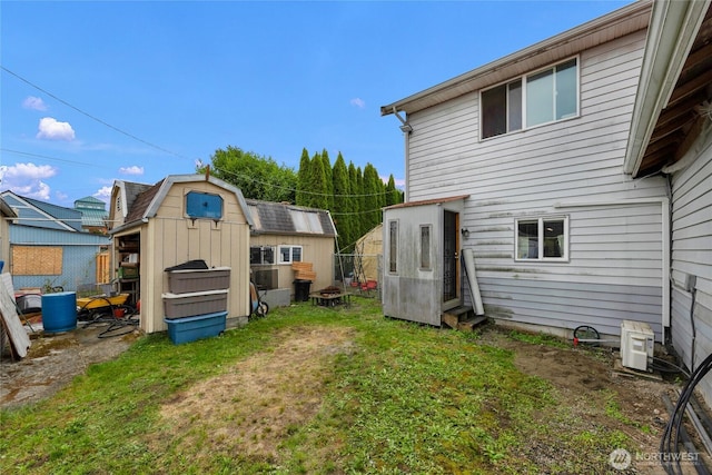 723 E 54th St, Tacoma, WA 98404 - rear view of house with an outbuilding, a yard, and a storage unit