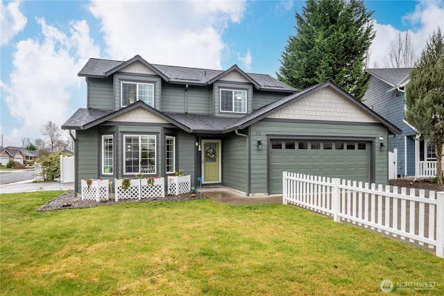 traditional-style house featuring a front lawn, roof with shingles, fence, and an attached garage