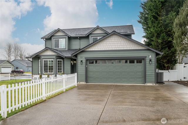 view of front of house featuring central air condition unit, a garage, a shingled roof, fence, and concrete driveway