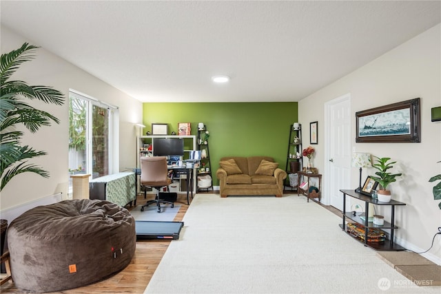 living area with light wood finished floors and baseboards