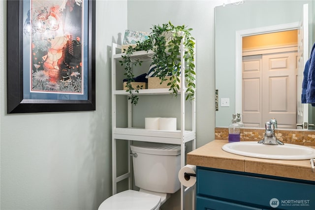 bathroom featuring vanity and toilet