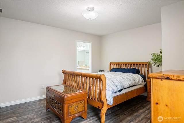 bedroom featuring connected bathroom, a textured ceiling, baseboards, and wood finished floors