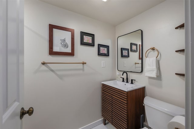 half bathroom featuring vanity and toilet