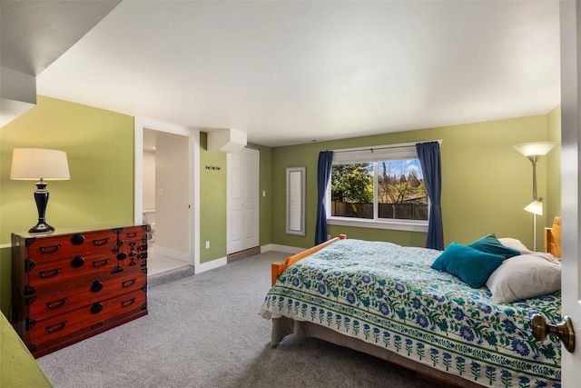 bedroom featuring baseboards and carpet