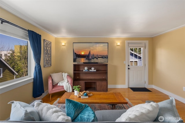 living area with baseboards and wood finished floors