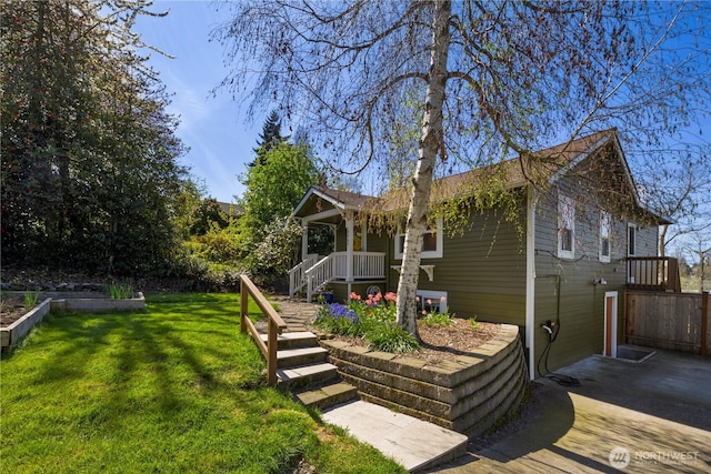 exterior space featuring a yard and covered porch