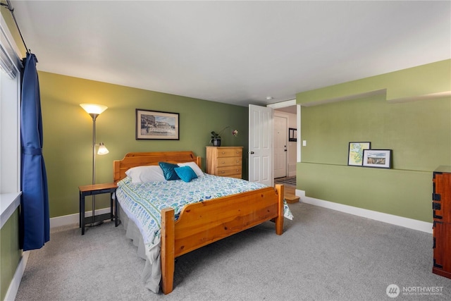 carpeted bedroom featuring baseboards