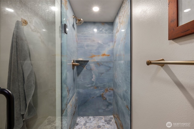 full bathroom with a marble finish shower
