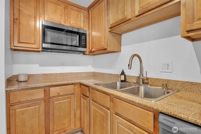 kitchen with stainless steel microwave, a sink, and dishwashing machine