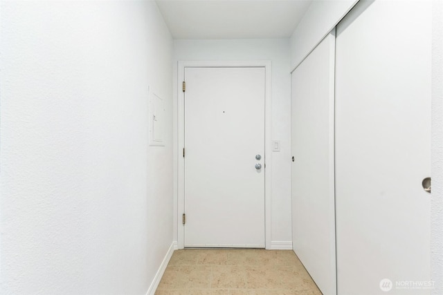 doorway to outside featuring baseboards