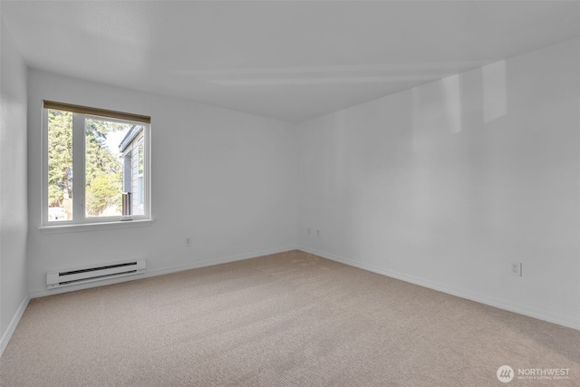 spare room featuring a baseboard radiator, carpet flooring, and baseboards